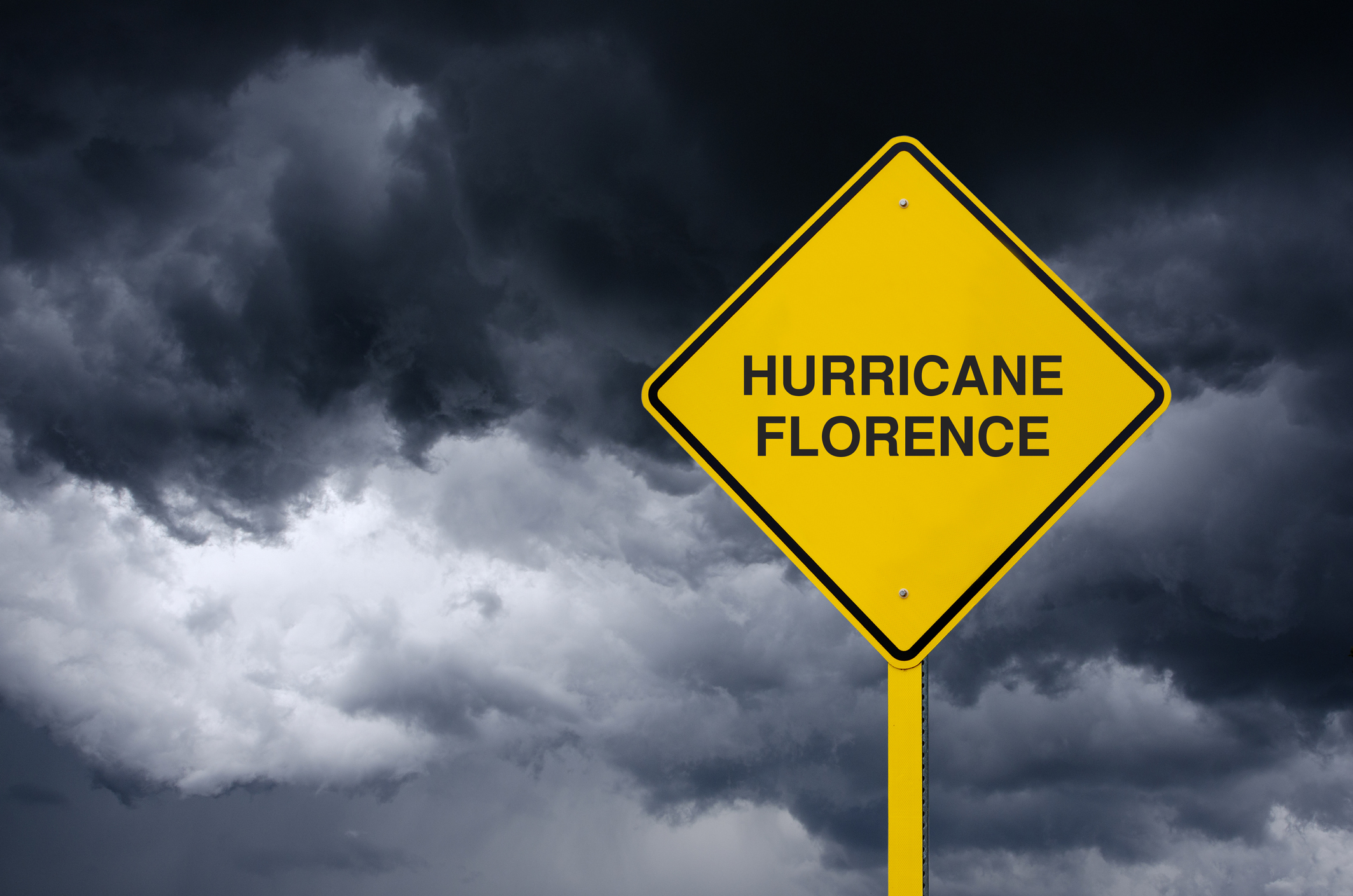 Road sign of hurricane florence in front of storm clouds 1036985136 2131x1412